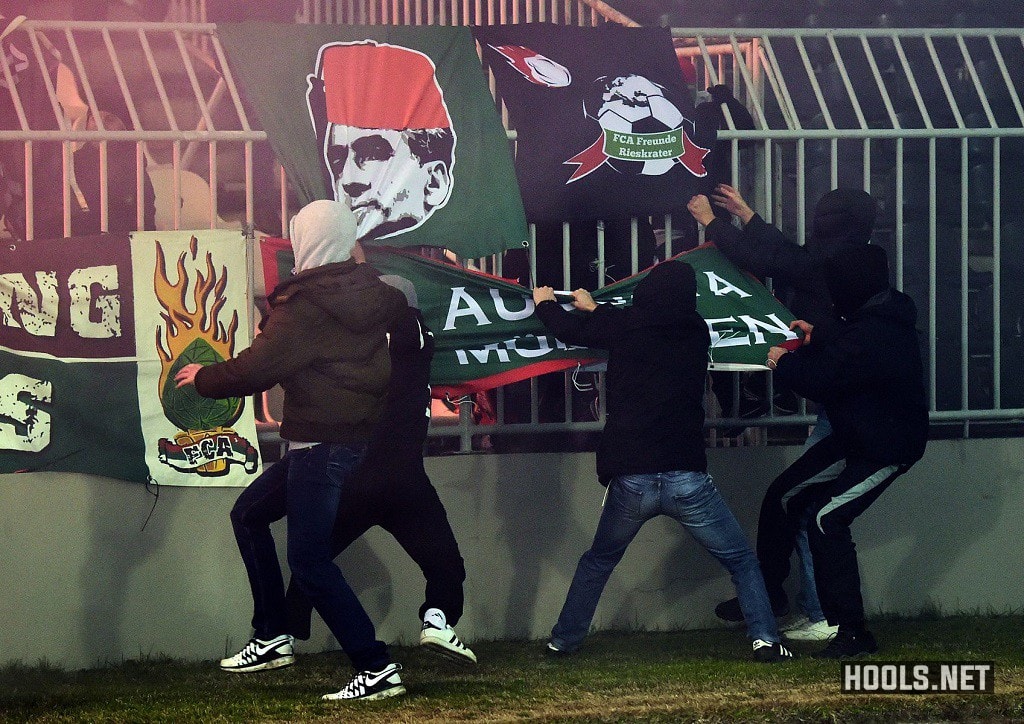 Partizan hooligans tear down Augsburg flags during the Europa League match.