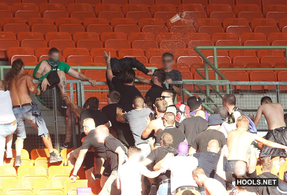 Austria Vienna and Rapid Vienna fans fight in the stands after the final whistle.