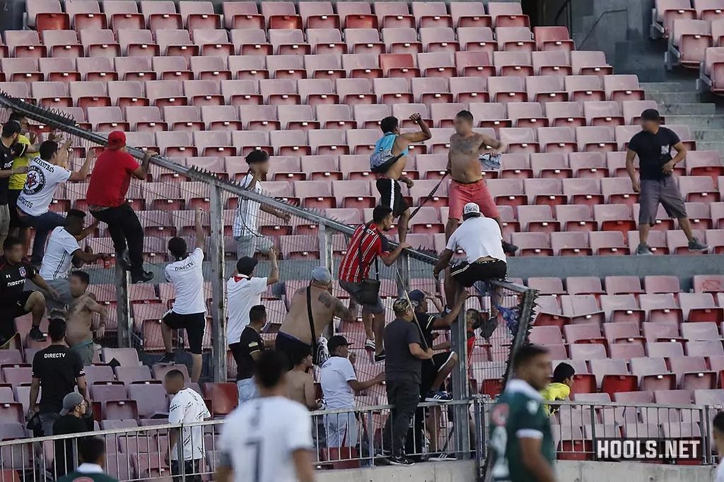 Colo-Colo and Santiago Wanderers fans clash in the stands during the Chilean Super Cup final.