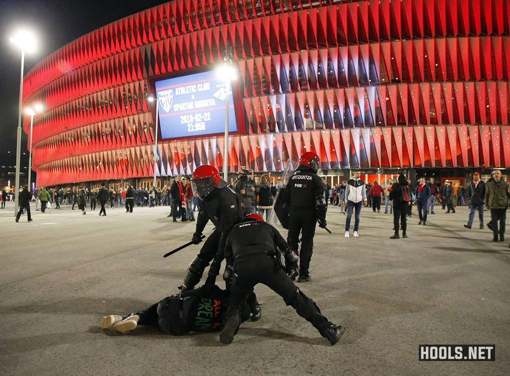 Cops detain a man during riots in Bilbao