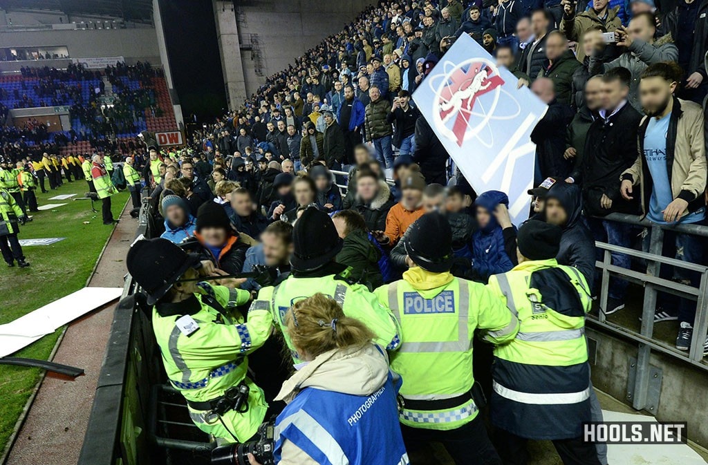 Manchester City fans confront police at the DW Stadium
