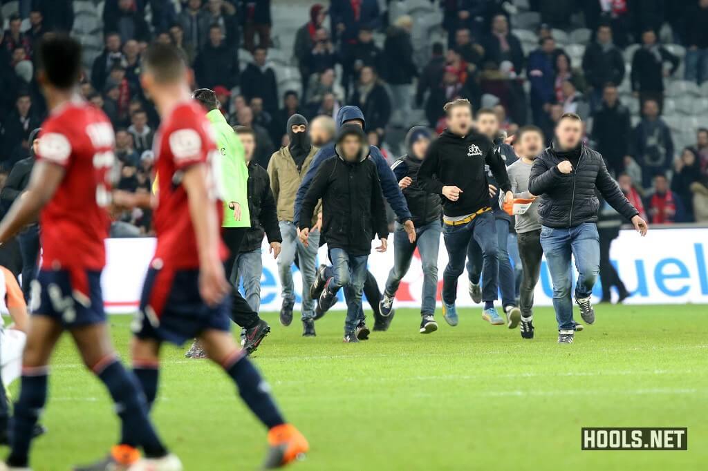 Lille fans invade the pitch at the end of the match