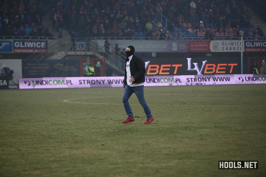 A Piast Gliwice fan walks towards the away end