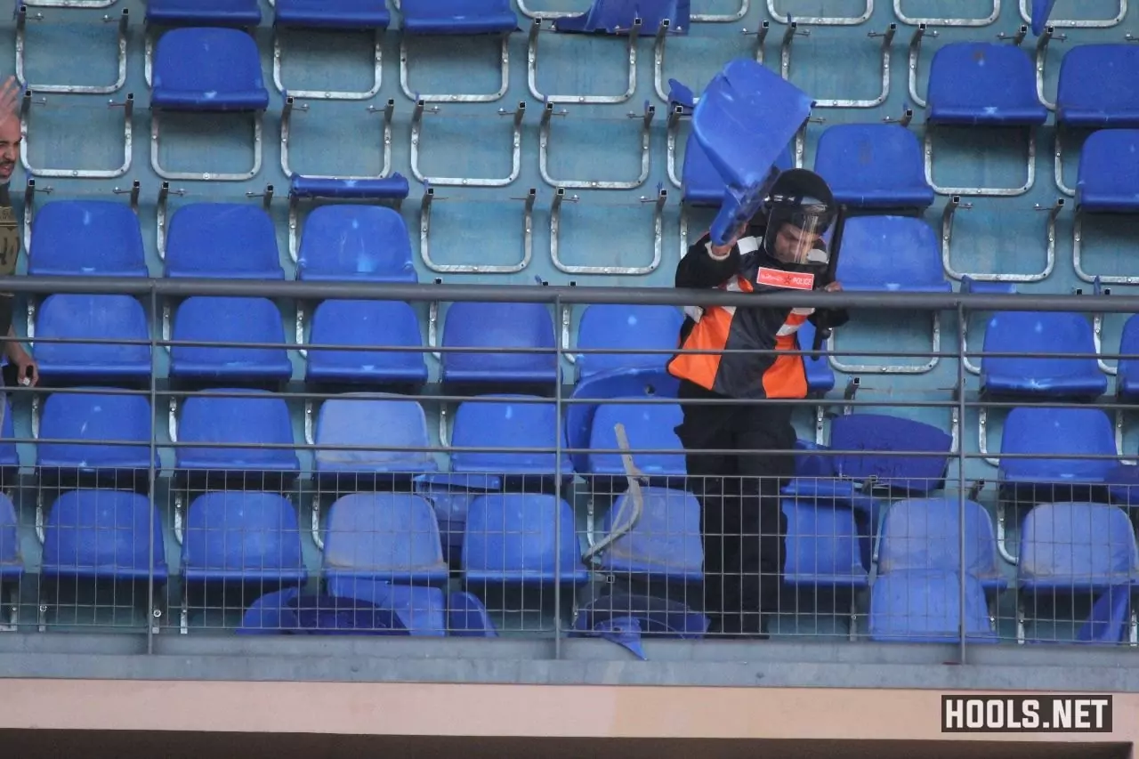 A cop hurls a seat at Raja Casablanca supporters