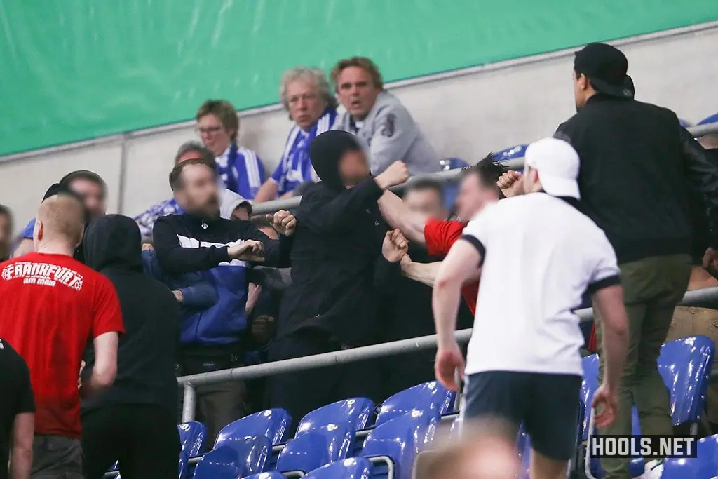 Schalke and Eintracht Frankfurt hooligans clash following the full-time whistle of their DFB Pokal match