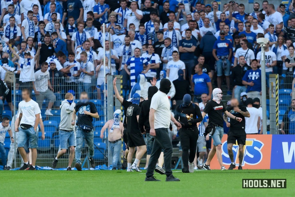 Lech Poznan hooligans invade the pitch during their clash against Legia.