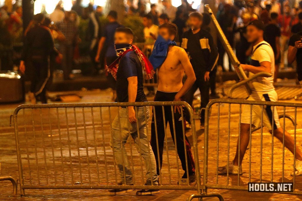 France fans clash with riot cops on the Champs Elysees after their national team's World Cup semi-final match against Belgium