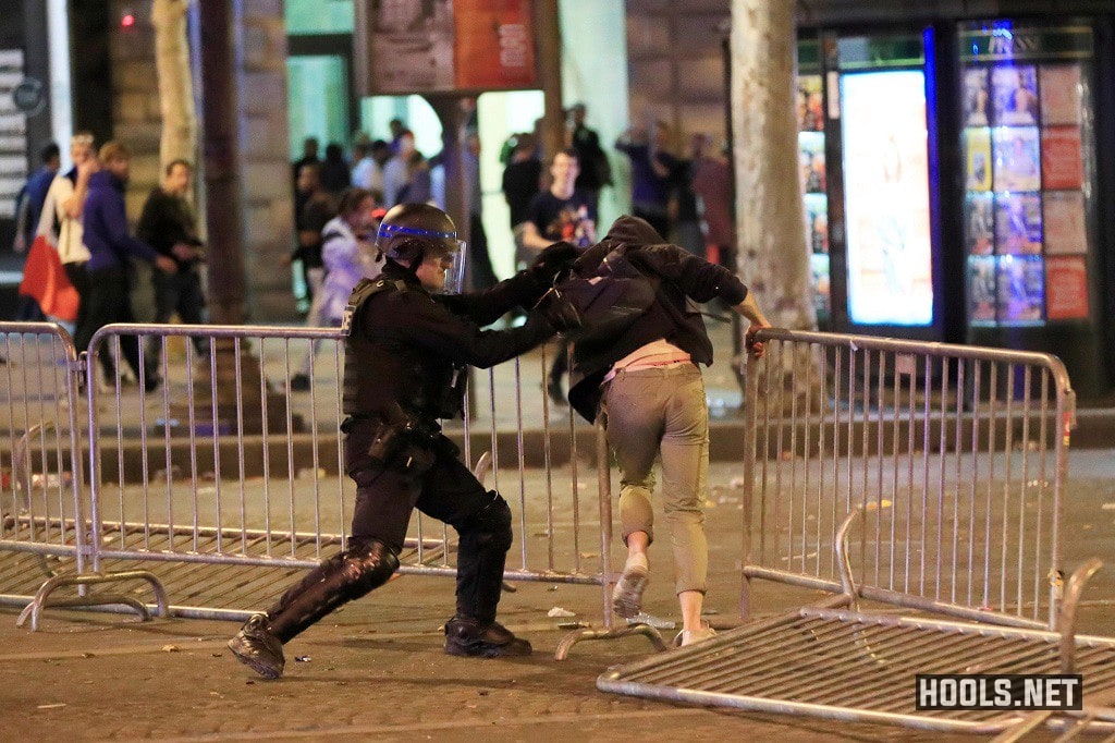 A French cop hits a fan during the clash