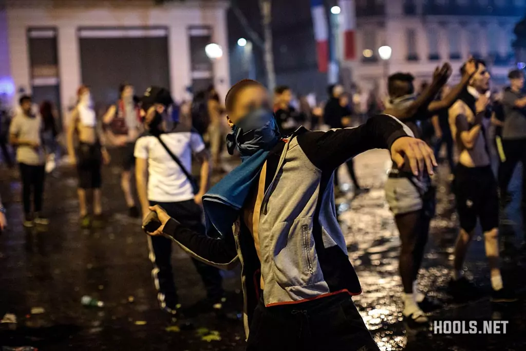 A man throws a stone during the clashes, which followed celebrations around the Arc de Triomph.