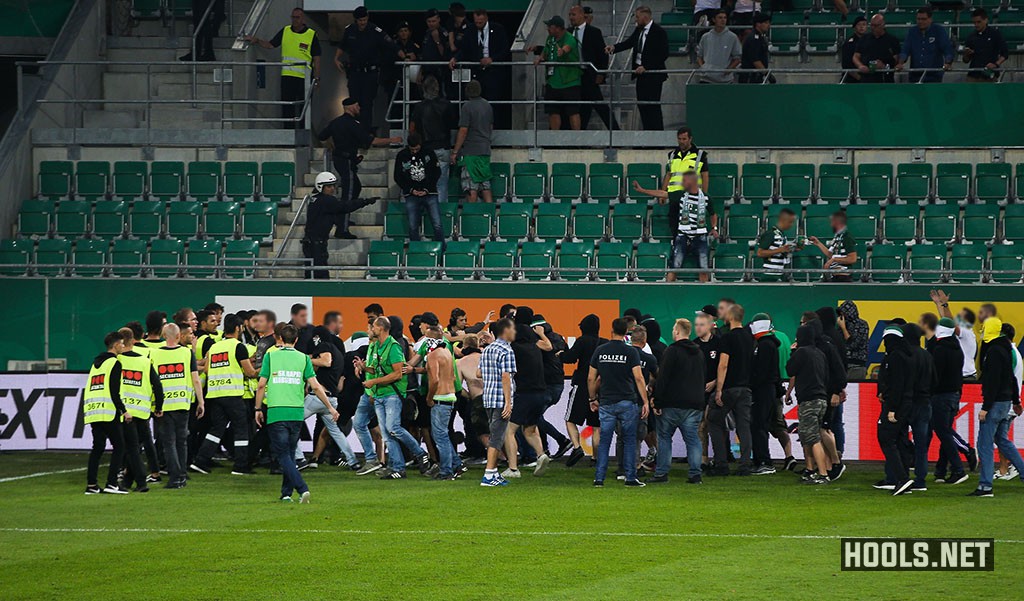 Rapid Vienna hooligans confront stewards at the end of their side's match against Austria