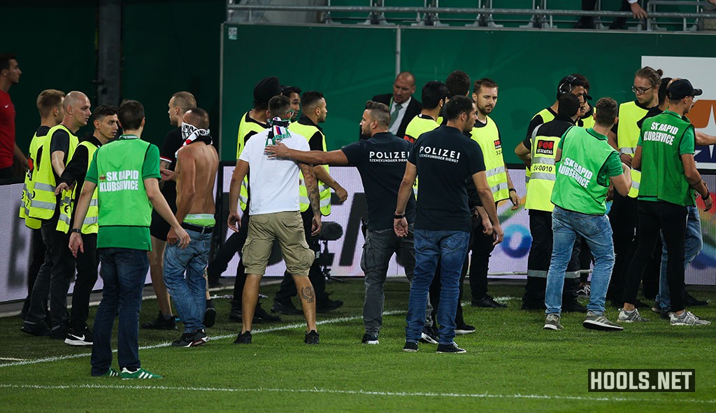 Rapid Vienna hooligans confront stewards at the end of their match against Austria