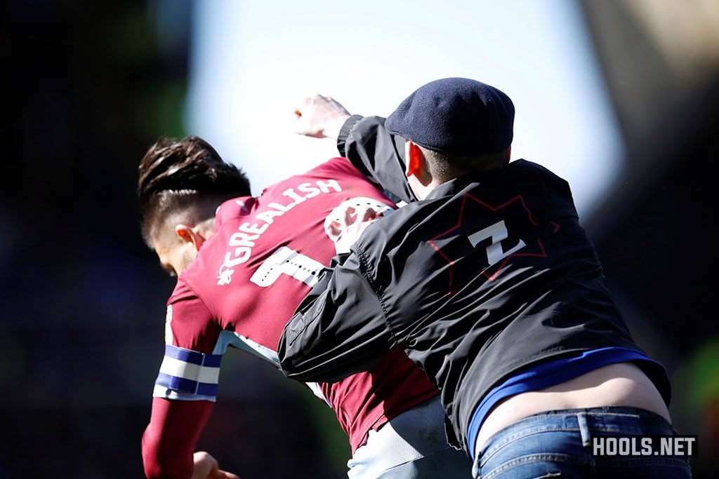A Birmingham City fan attacks Aston Villa midfielder Jack Grealish during the Second City derby.
