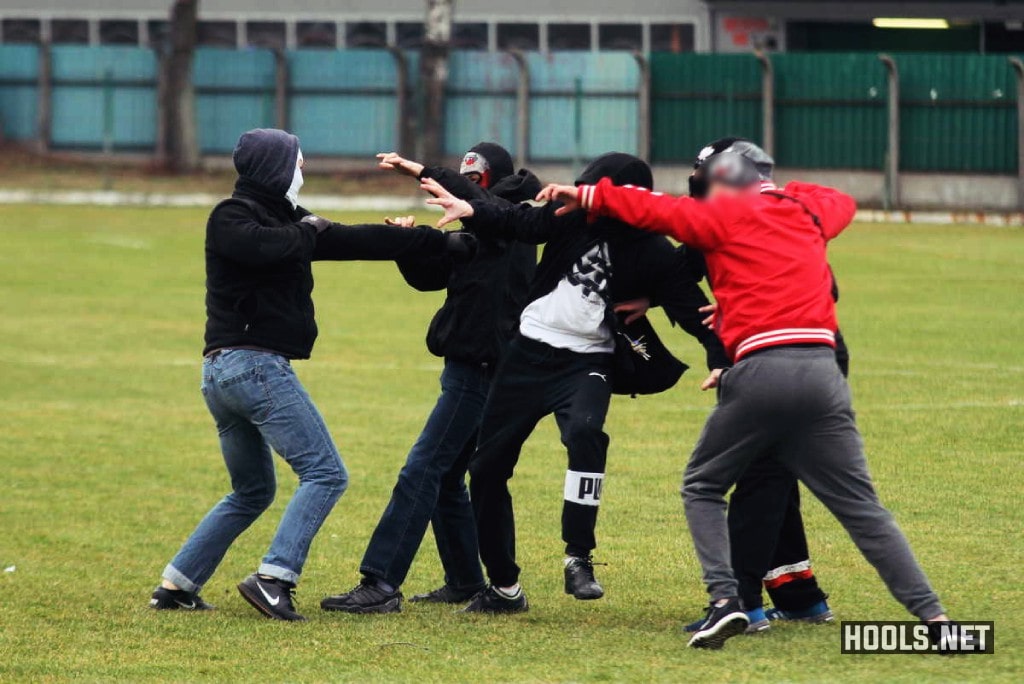 Okocimski Brzesko and Tarnovia Tarnow fans fight after they invade the pitch.