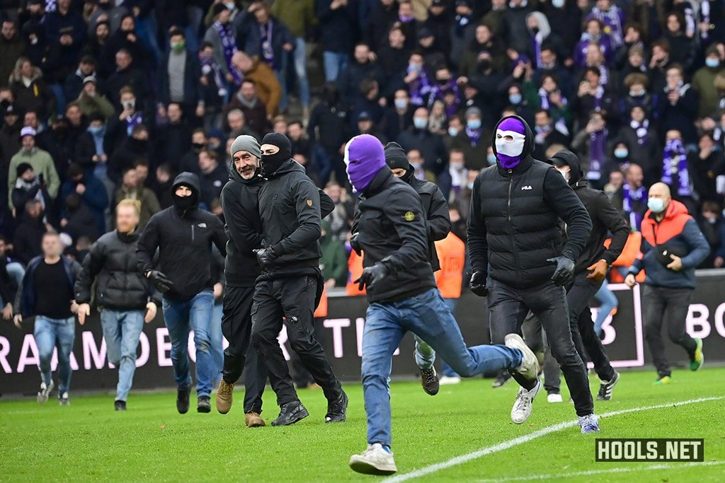 Beerschot fans invade the pitch after their side's Belgian Pro League match against Antwerp.