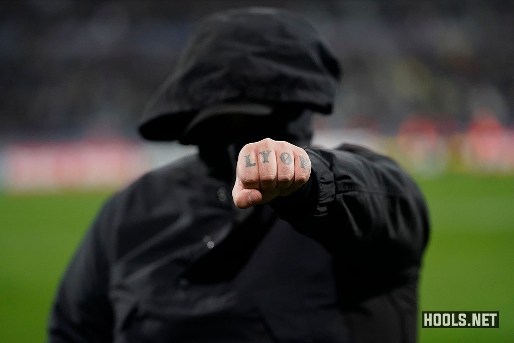 A Lyon fan shows off his tattoo.