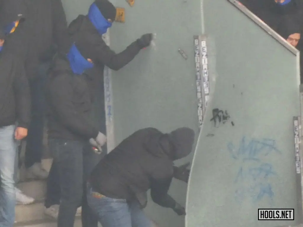 Eintracht Braunschweig hooligans break the fence that split the away end in two