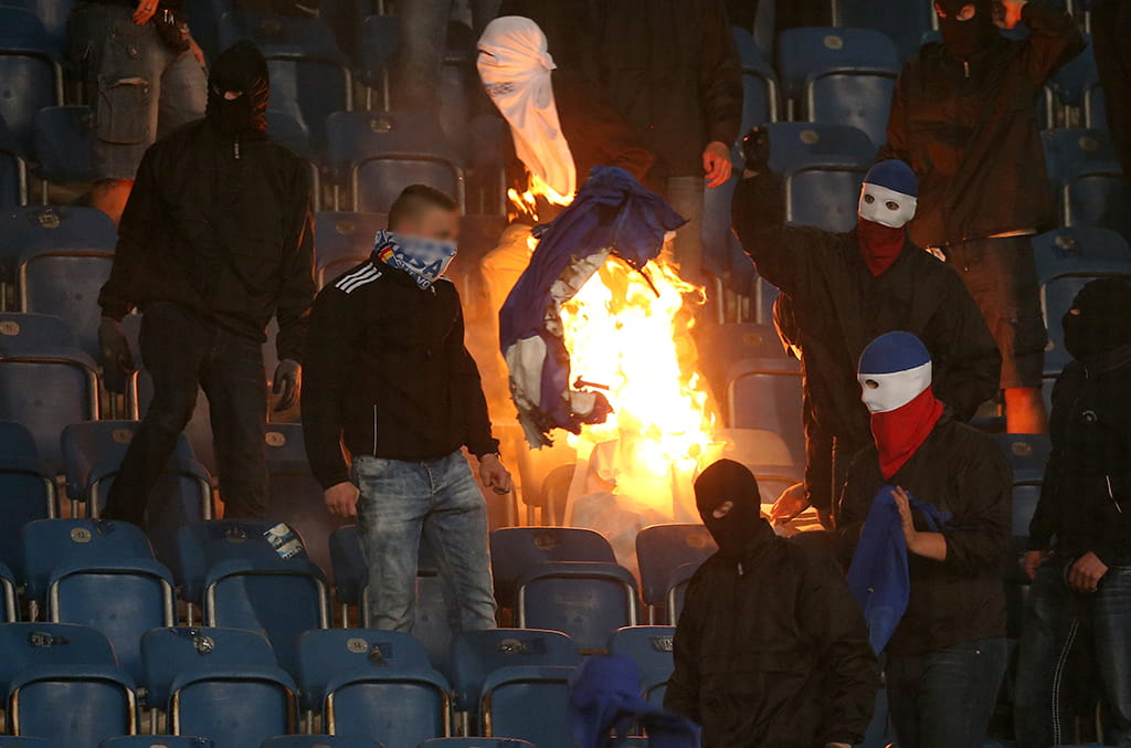 Hansa Rostock hooligans set fire to a Hertha Berlin banner during their German Cup clash