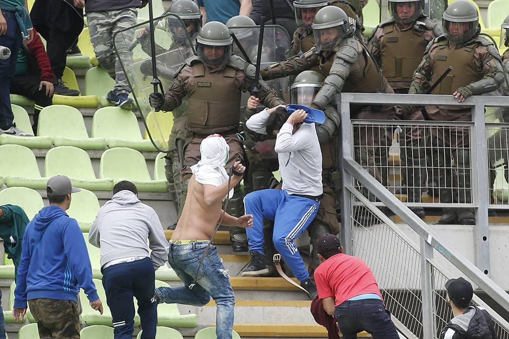 Santiago Wanderers fans fight each other during Cobresal game
