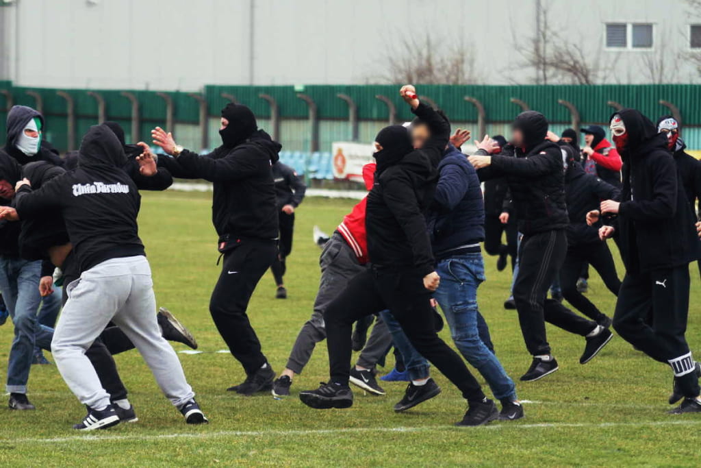 Polish lower-league match abandoned as fans clash on the pitch