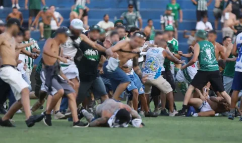 Rival fans fight on pitch during Coritiba v Cruzeiro match