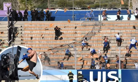 Rival fans throw seats at each other and clash with police during Argentinian cup tie
